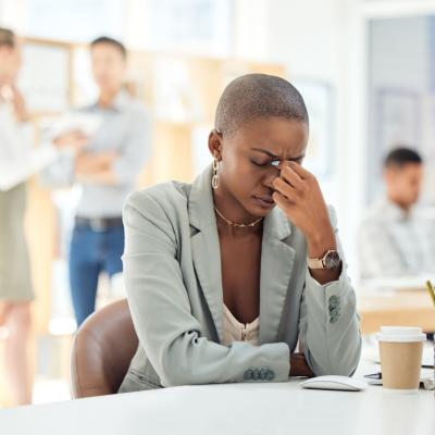 Stressed woman sitting at her desk in an office. 