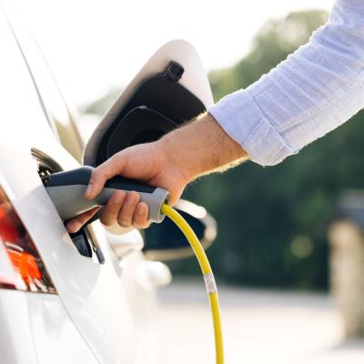 Person fueling hybrid car.