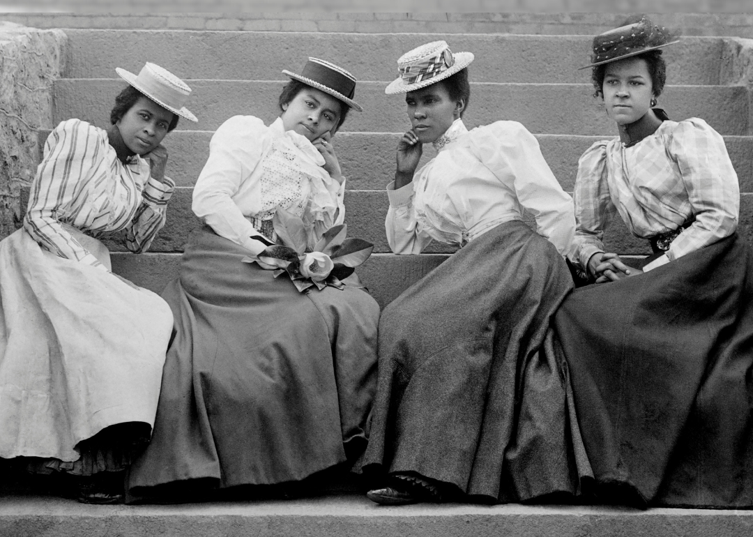 Four Black women sitting on steps of Atlanta University.
