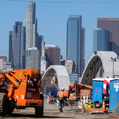 Road construction with Los Angeles skyline.