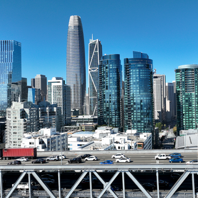Cars drive the San Francisco skyline along Interstate 80.