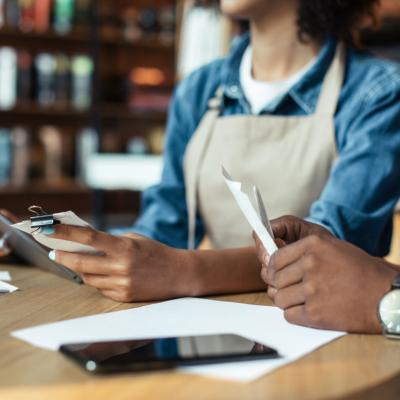 Small business owners reviewing receipts.