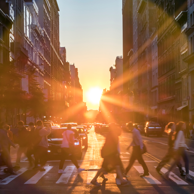 Sun setting between buildings in midtown Manhattan.