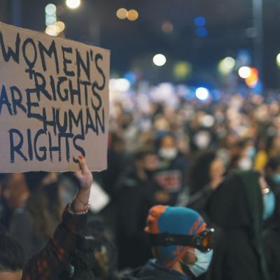 Person holds up a sign that reads "Women's rights are human rights" at a protest