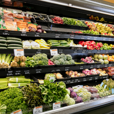 Grocery store shelves filled with produce.