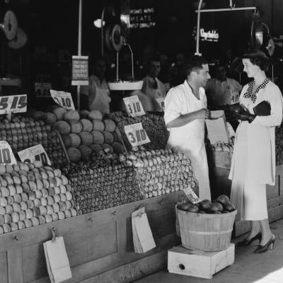 Vintage photo of woman and vendor at open air market