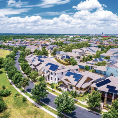Aerial view of large homes in summer.