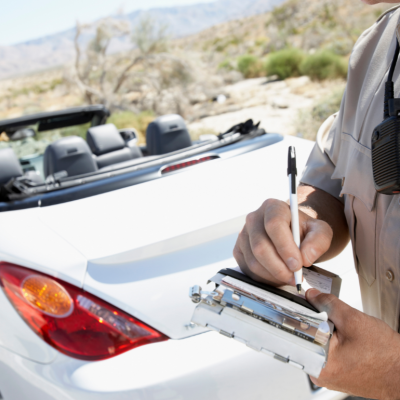 A cop writing a speeding ticket