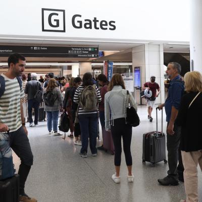 Travelers line up to enter a security checkpoint in the international terminal at San Francisco International Airport on July 01, 2022 in San Francisco, California.