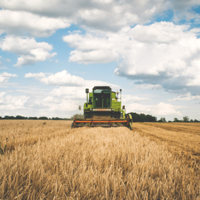 Tractor moves across dry field