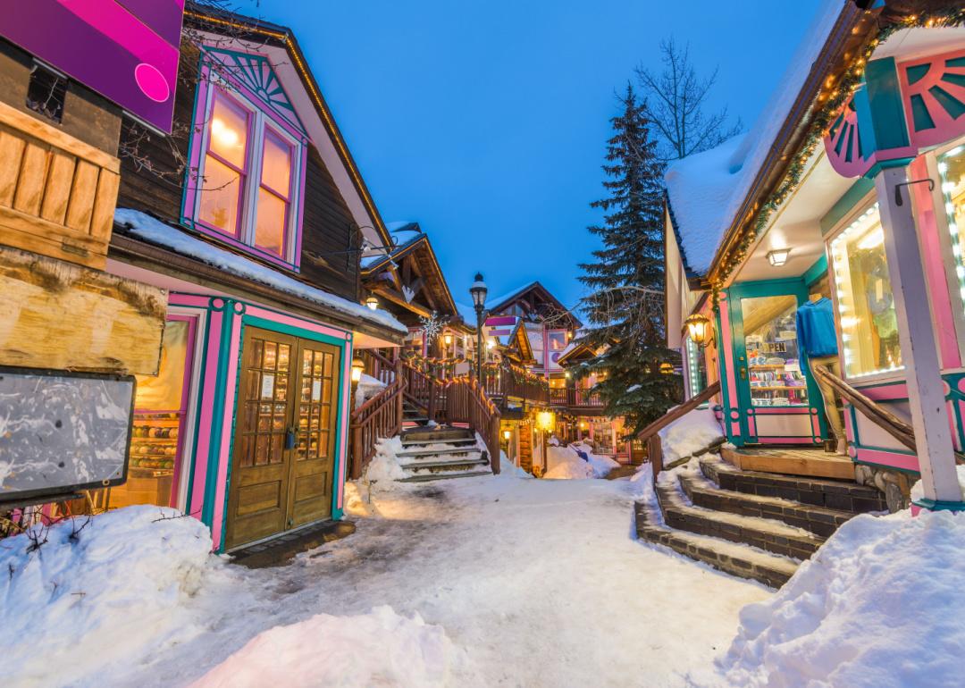 Downtown streets of Breckenridge, Colorado at night in the winter with holiday lighting.