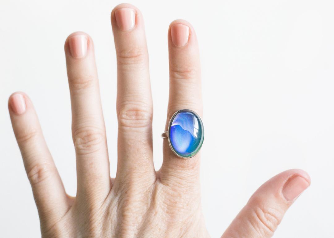 Vintage mood ring on index finger.