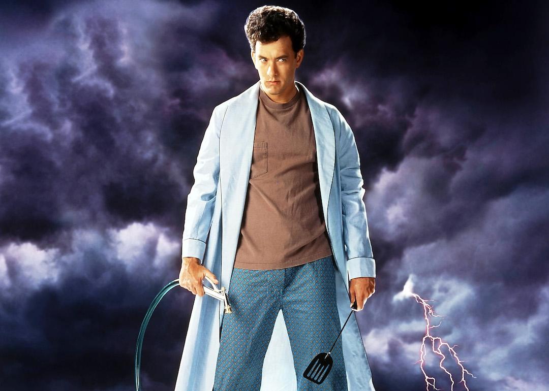 Actor Tom Hanks holding a hose and spatula in the movie art for the 1989 comedy film 'The 'Burbs.'