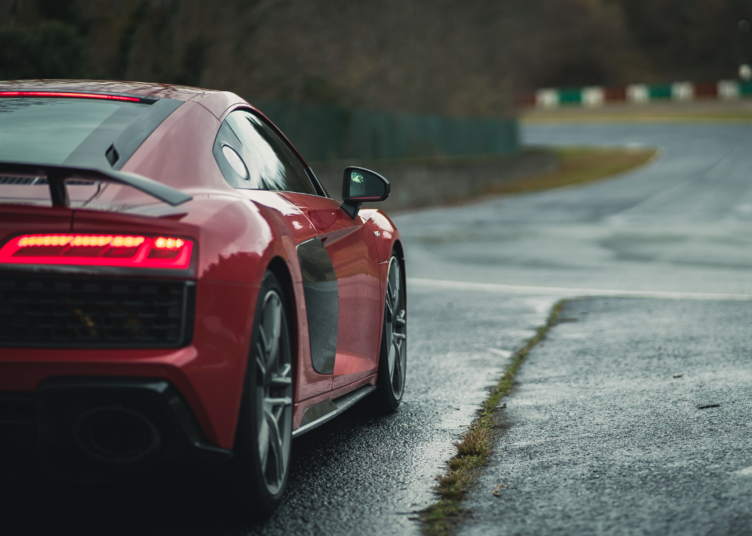 Red sportswear driving down road.