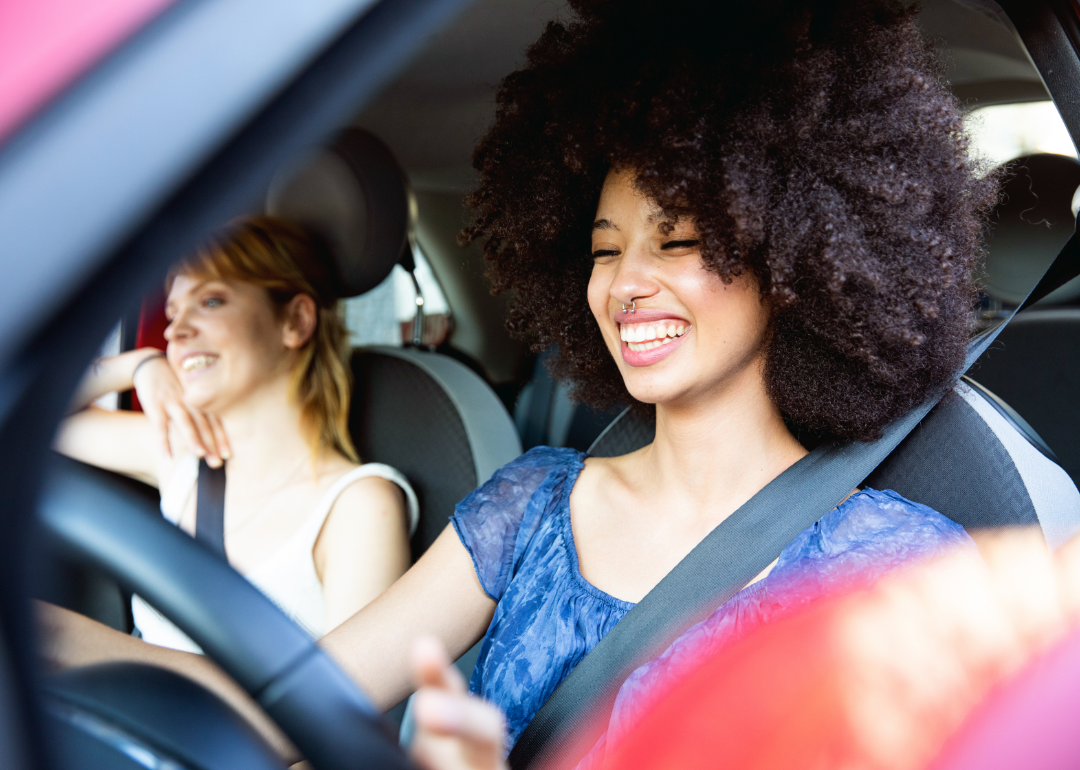 A smiling driver and her passenger. 