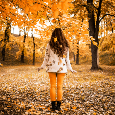 A woman standing in a forest in autumn