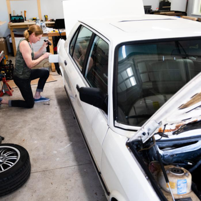 Anna Ray, a transgender woman, performs repairs on her vintage BMW