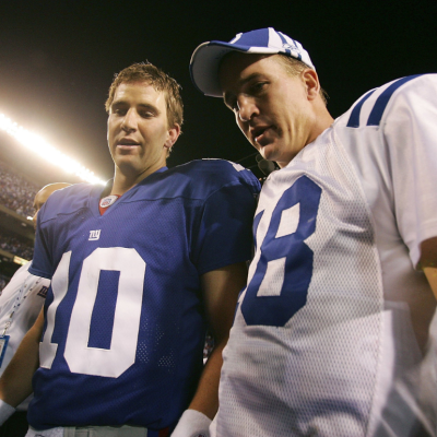Quarterback Eli Manning #10 of the New York Giants (L) congratulates his brother quarterback Peyton Manning #18 of the Indianapolis Colts on his 26-21 victory on September 10, 2006 at Giants Stadium in East Rutherford, New Jersey. 