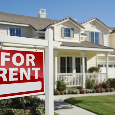 A home with a for rent sign in front