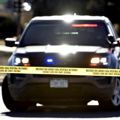 Police officers investigate one of several crime scenes from a shooting spree at 8th Avenue and Zuni Street on December 28, 2021 in Denver, Colorado. A disabled vehicle with a flat tire and shot out window remains in the intersection. A suspect went on a shooting spree on Monday night that spanned two cities, Lakewood and Denver, and claimed the lives of four people and wounded three people including a Lakewood police officer. 