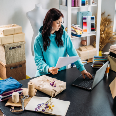 A female small business owner prepares to drop ship products ordered online from her store.