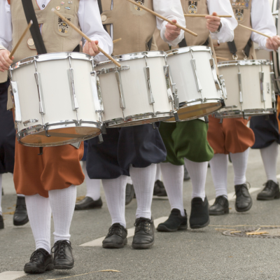 A line of costumed Civil War era drummers walking in a Thanksgiving Day Parade