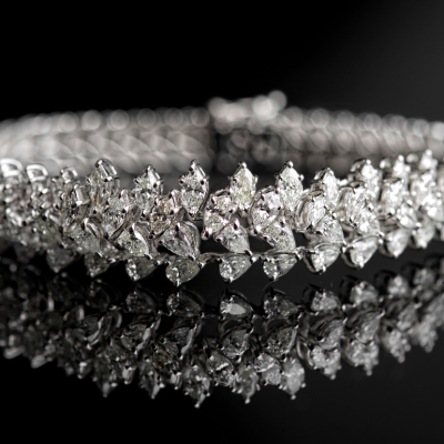 A diamond bracelet shown against a black backdrop.