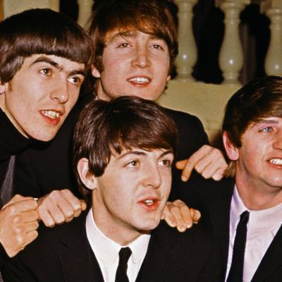 The Beatles smiling together: from left to right: George Harrison, John Lennon, Paul McCartney, and Ringo Starr.
