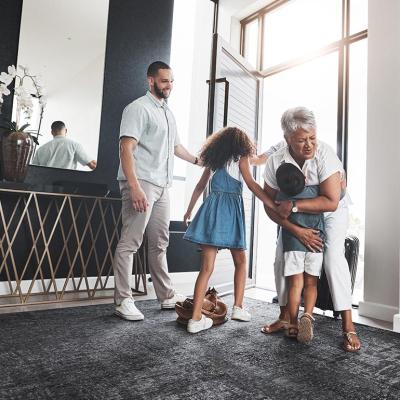 grandparent visiting children and grandchildren in nice home
