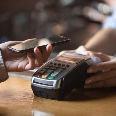 woman spending money and paying via smartphone