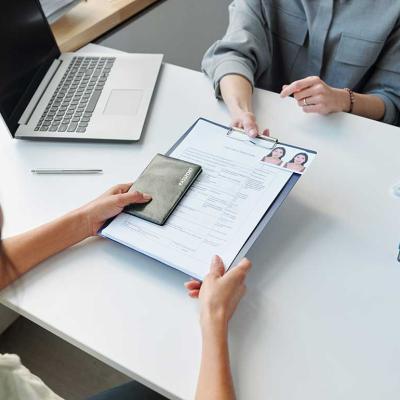 person submitting legal documents across desk