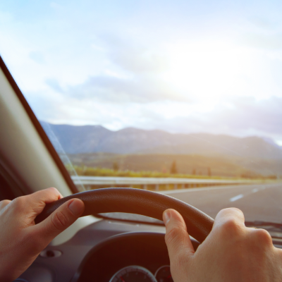 POV of driver looking at road over steering wheel