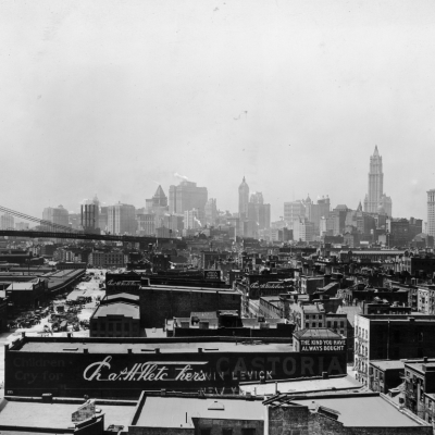 View of the buildings at South Street Seaport and the Brooklyn Bridge, with the office buildings of Lower Manhattan in the background.