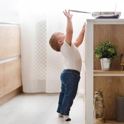 child reaching for stove