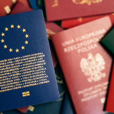 European Union blue biometric passport on background of passports of different countries