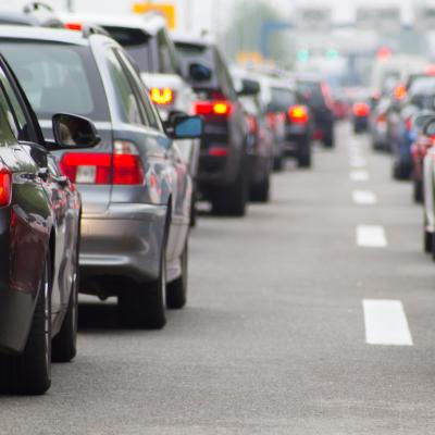 Two lanes of cars in a traffic jam on a highway.