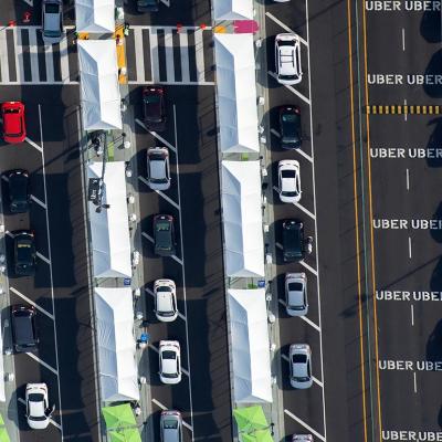 aerial view of line of ubers waiting to enter rideshare lot