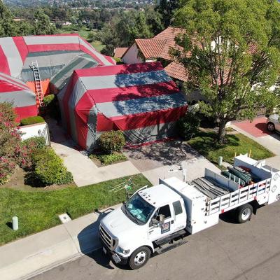 red and green tent covering home being fumigated
