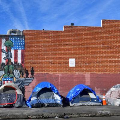 Tents for the homeless line a sidewalk in Los Angeles, California.