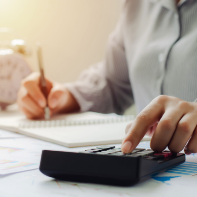 Person doing paperwork and using a calculator