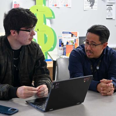 Rene Torres, left, works on his FAFSA with Denver Scholarship Foundation college adviser Federico Rangel at Denver's West High School in April.