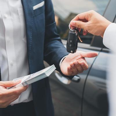 A car buyer receives the car keys to his purchase.