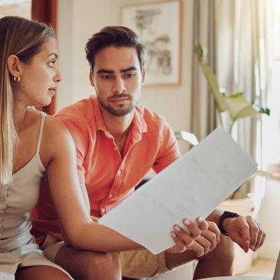 A couple looking at financial documents having a discussion.