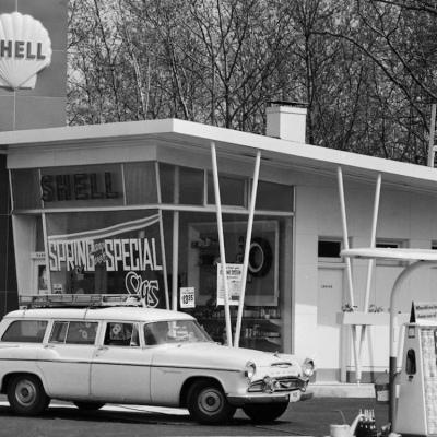A car sits in front of a Shell gas station in 1958.