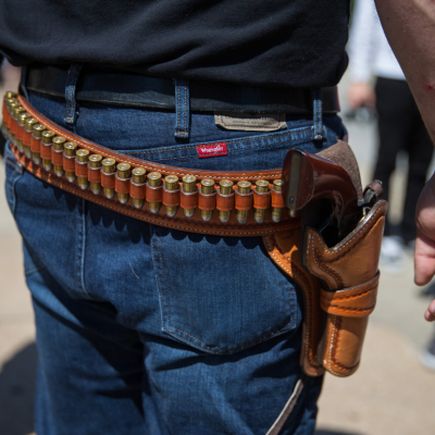 Person carrying gun and ammunition on holster at a counter-protest in response to protesters opposing the NRA's annual convention on Saturday, May 5, 2018 in Dallas, Texas.