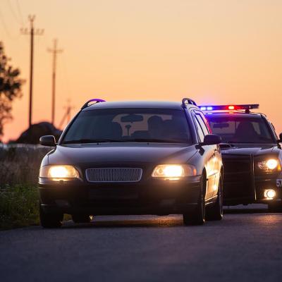 Car on the road being followed by police.