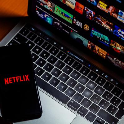 Phone and laptop displaying Netflix selections.