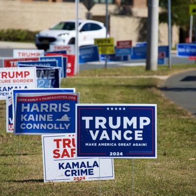 Campaign signs placed on a median lawn for presidential candidates in Fairfax, VA.