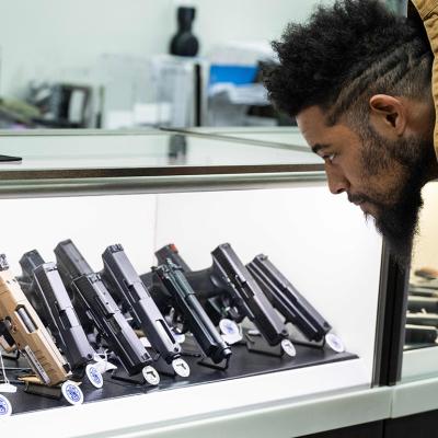 Jordan Landis, a gun collector, looks at guns in EJB's Gun Shop in Capitol Heights, Maryland.