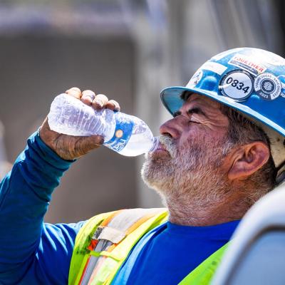 A construction worker takes a water break during a heat wave in California. 